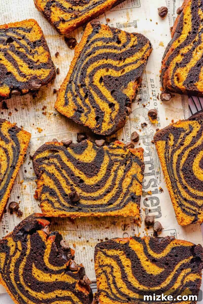 Pumpkin Chocolate Tiger Stripe Bread 3 Multiple slices of quick bread are placed on a surface covered with newspapers.