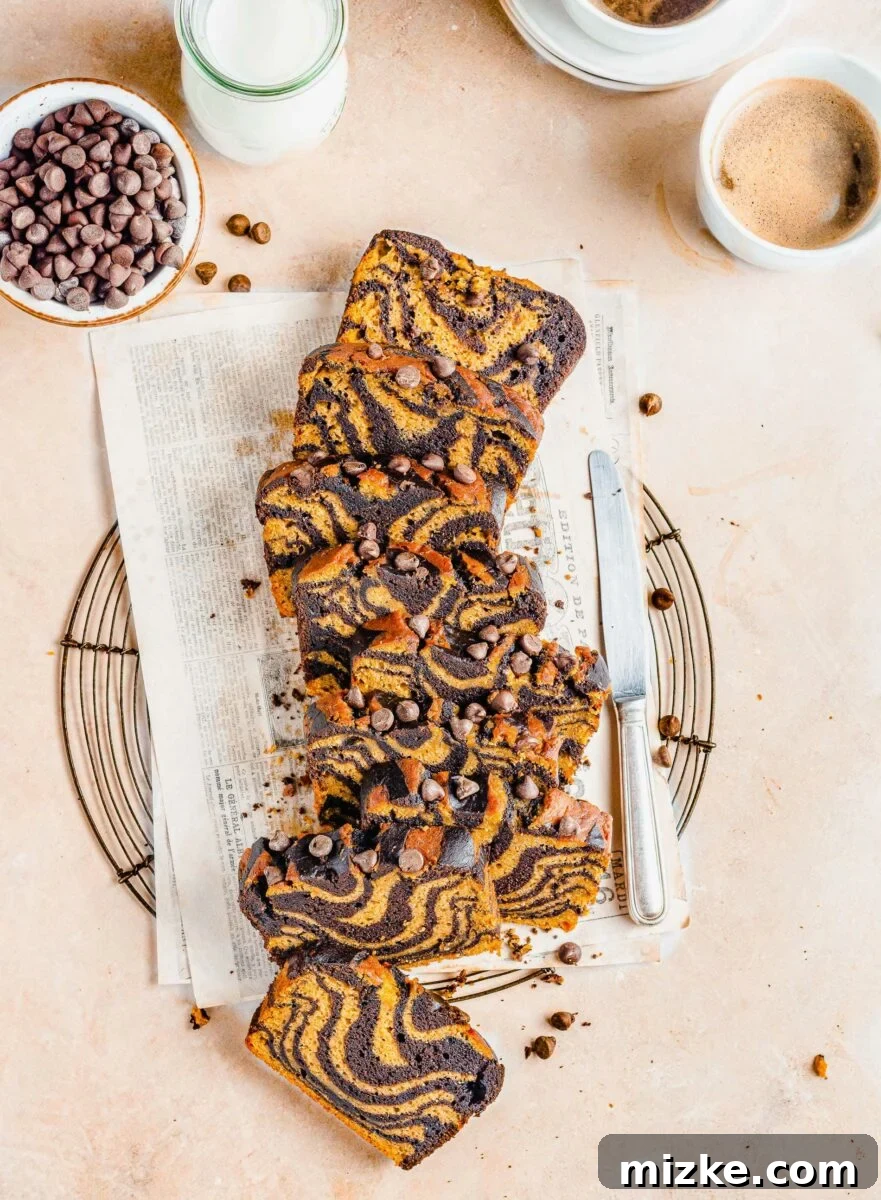 Pumpkin Chocolate Tiger Stripe Bread 4 Several slices of bread are placed next to a butter knife.