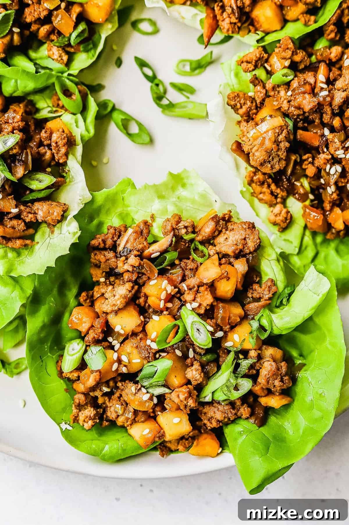 These chicken lettuce wraps are made with crisp lettuce, juicy ground chicken, tender shiitake mushrooms, and a sweet and tangy sauce! Beautifully arranged chicken lettuce wraps with water chestnuts, ground chicken, and shiitake mushrooms, ready to be enjoyed as a meal.