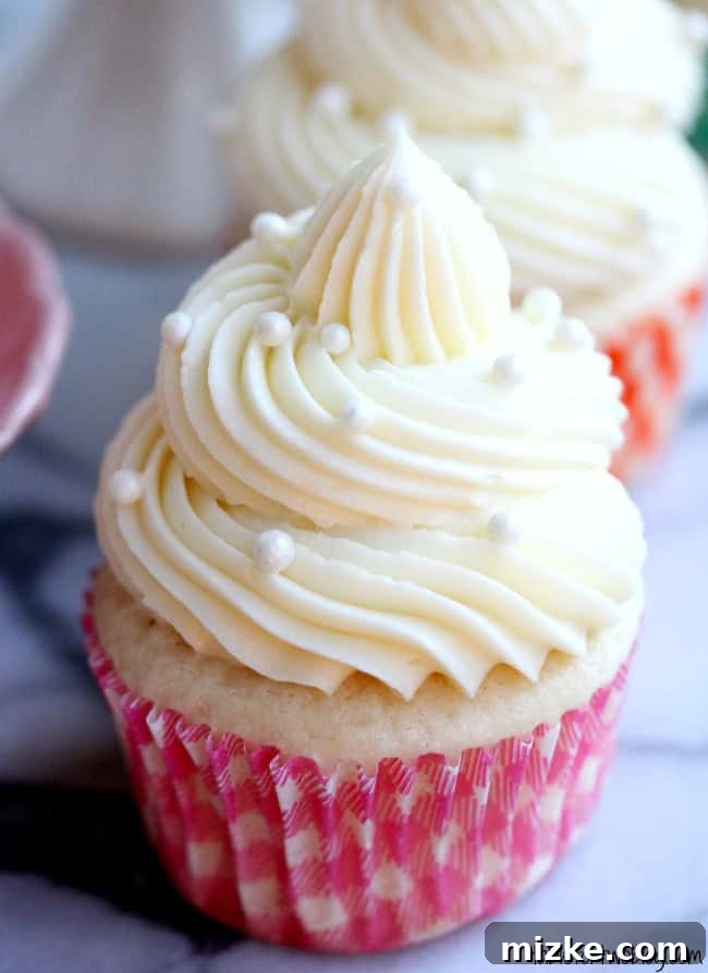 Bridal Bliss Cupcakes 3 Close-up of a white wedding cake cupcake with intricate frosting details