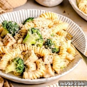 Creamy Chicken and Broccoli Alfredo 2 Chicken broccoli Alfredo pasta in a bowl with a fork.