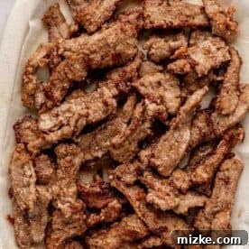 Sweet and Savory Mongolian Beef 11 A plate of cooked beef strips on a paper towel.