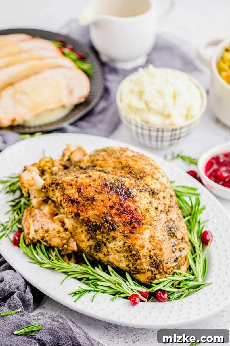 Perfect Instant Pot Turkey Breast 11 A beautifully cooked Instant Pot Turkey Breast, garnished with fresh rosemary and bright cranberries, making a festive presentation.