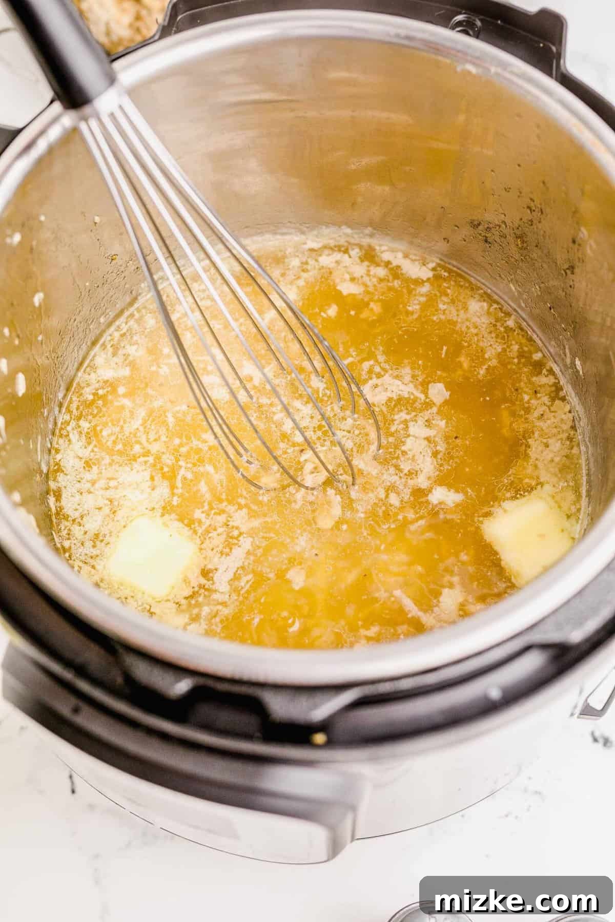 Perfect Instant Pot Turkey Breast 9 Whisking the butter in the insert of the Instant Pot to melt it, beginning the gravy-making process.