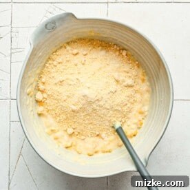 Hearty Cornbread Delight 9 cornbread mix added to corn mixture in a bowl