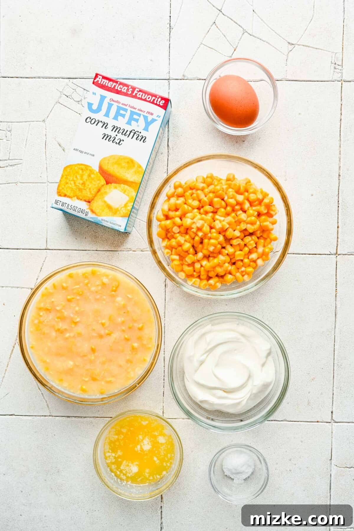 Hearty Cornbread Delight 2 A vibrant flat lay showcasing all the essential ingredients needed for cornbread casserole, neatly arranged on a rustic wooden surface.