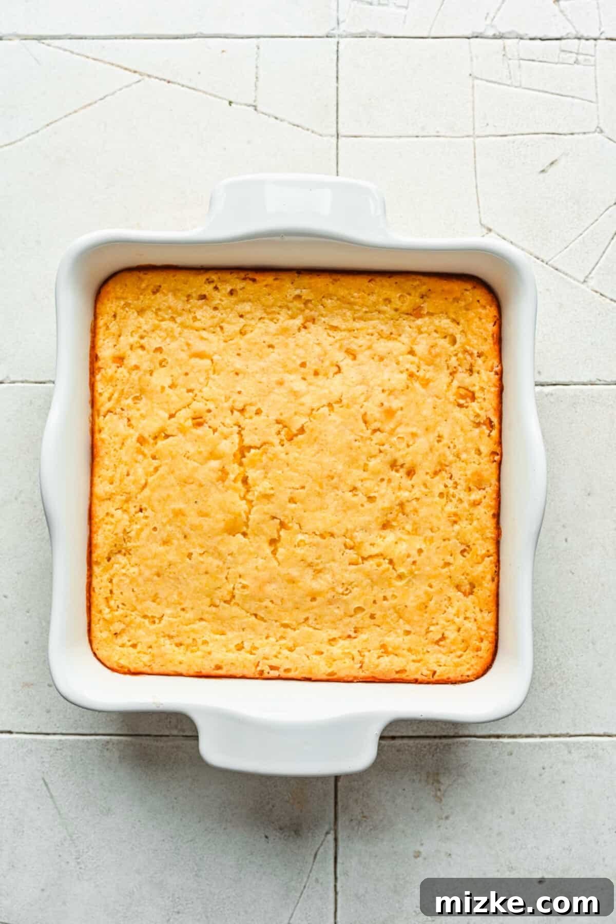 Hearty Cornbread Delight 6 The fully baked golden-brown cornbread casserole, with a perfectly crispy edge and soft center, just removed from the oven.
