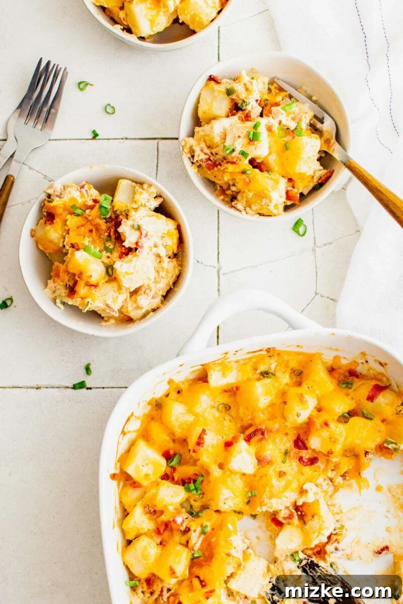 Loaded Potato Dream Bake 5 Two full white bowls are placed next to a half full casserole dish.