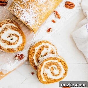 Overhead view of a pumpkin roll cut into slices on a white countertop.