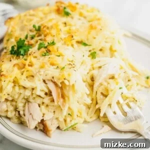 Creamy Turkey Tetrazzini 7 Finished Turkey Tetrazzini casserole in a baking dish with a serving removed.