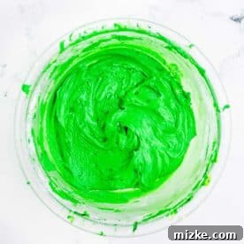 Vibrant dark green icing in a bowl, ready for decorating.