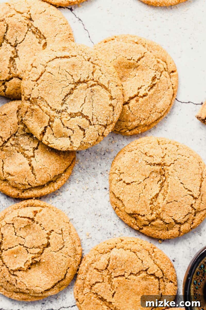 Warm Cinnamon Brown Sugar Delights 3 Lightly browned cookies are placed next to a cup of coffee on a countertop.