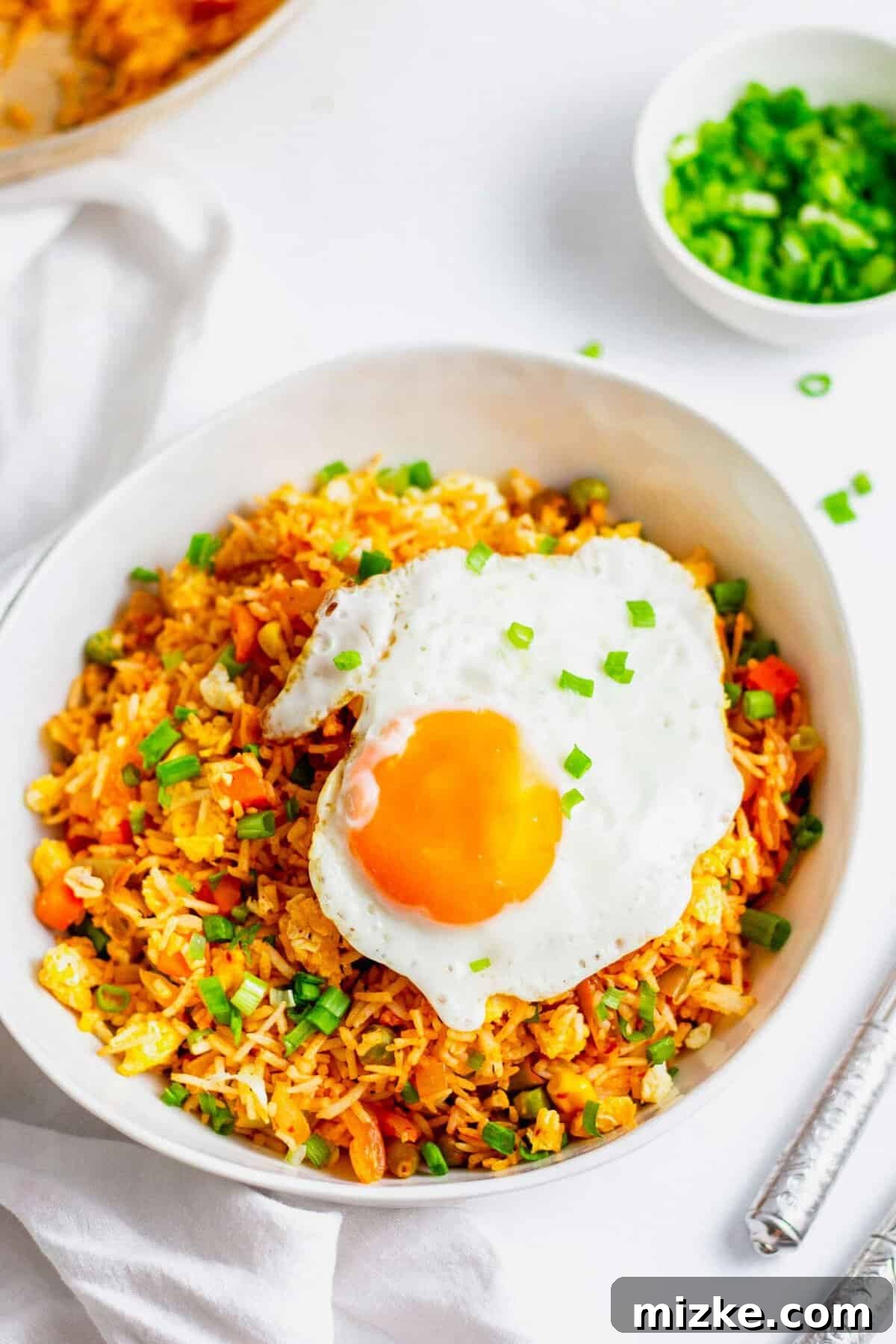 Sizzling Kimchi Fried Rice 4 Kimchi fried rice topped with fried egg and garnished with green onions