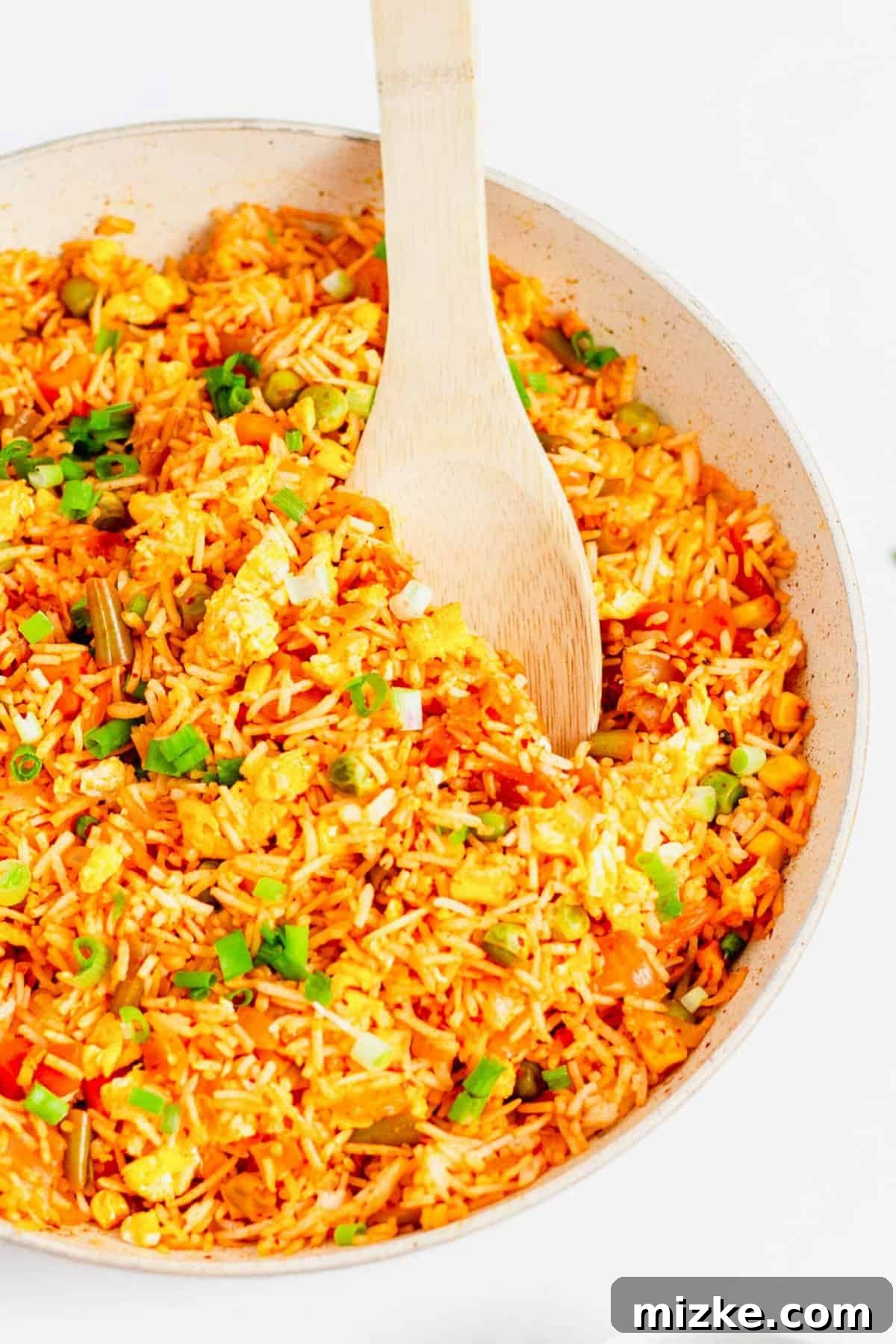 Sizzling Kimchi Fried Rice 6 Wooden spoon digging into large bowl of fried rice