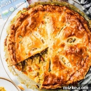 Overhead view of broccoli cheddar pot pie with one slice removed