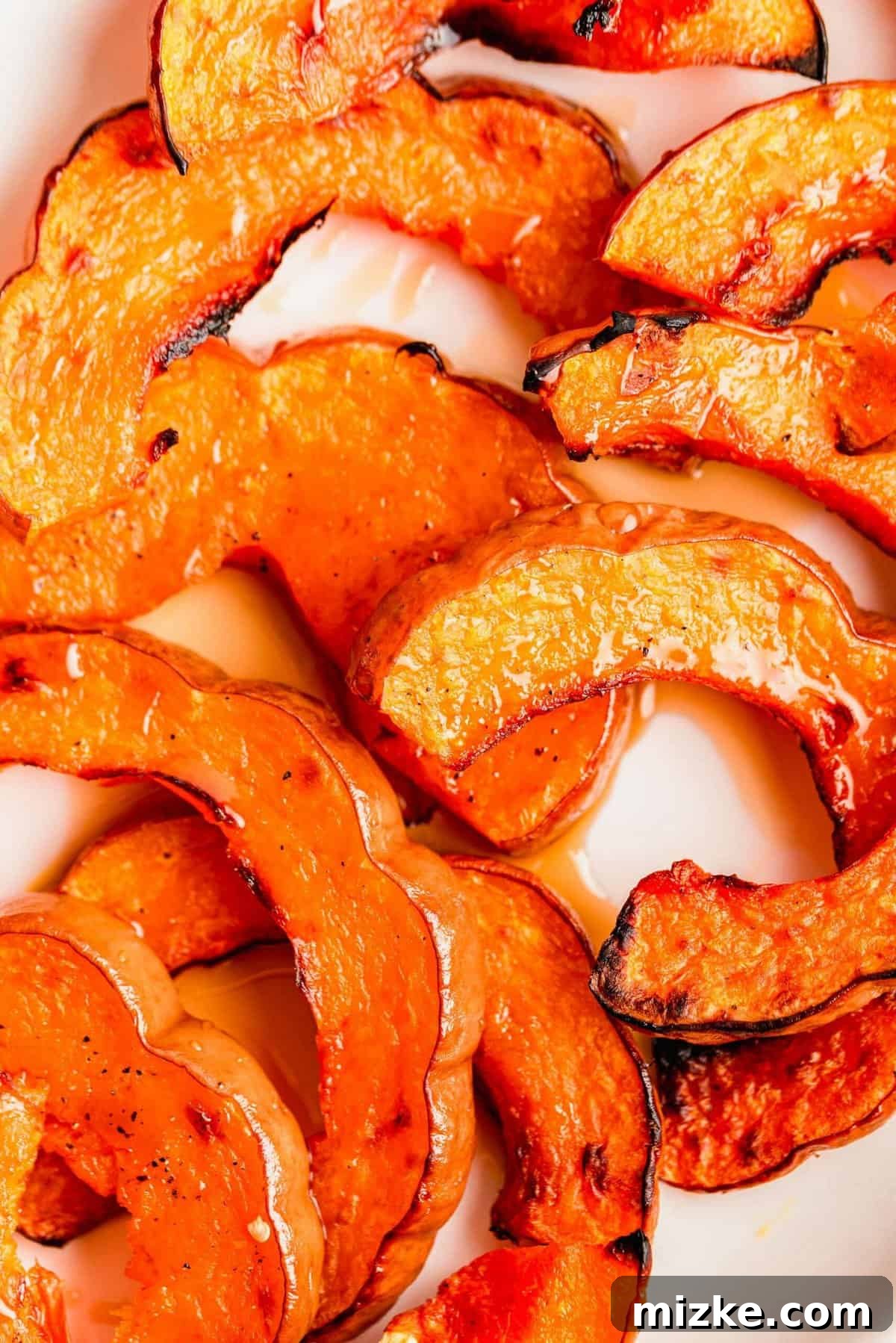 Golden Roasted Koginut Squash 7 A close-up view of beautifully caramelized and tender roasted koginut squash slices, showcasing their appealing texture.