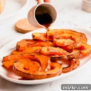 Pouring maple syrup over roasted koginut squash slices