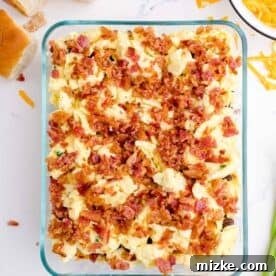 Crumbled bacon spread on top of scrambled eggs