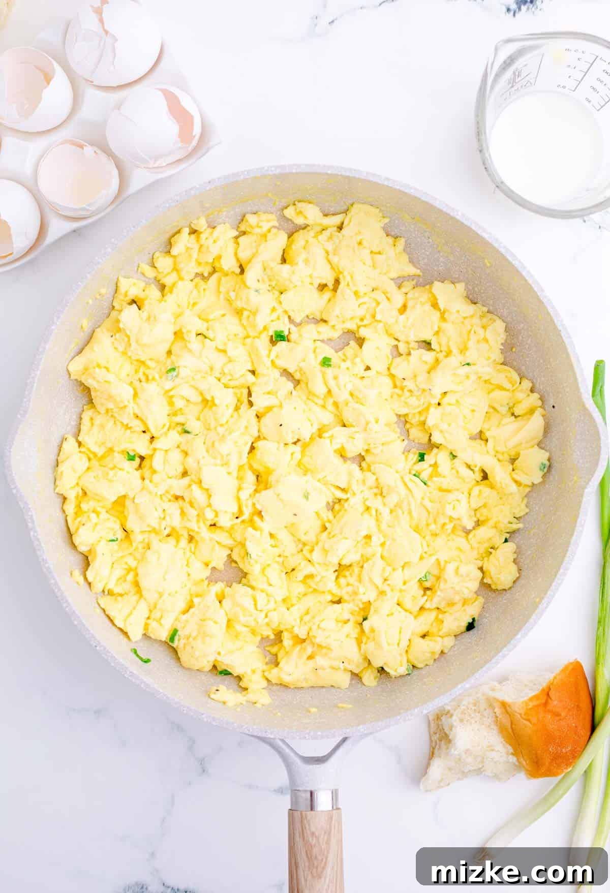 Morning Bites 10 Fluffy scrambled eggs cooking gently in a large skillet, stirred often to achieve perfect consistency