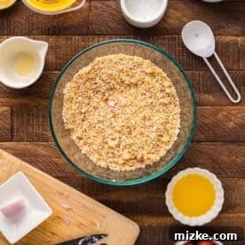 Panko breadcrumbs and other ingredients mixed in a shallow clear bowl, ready for coating the cod.