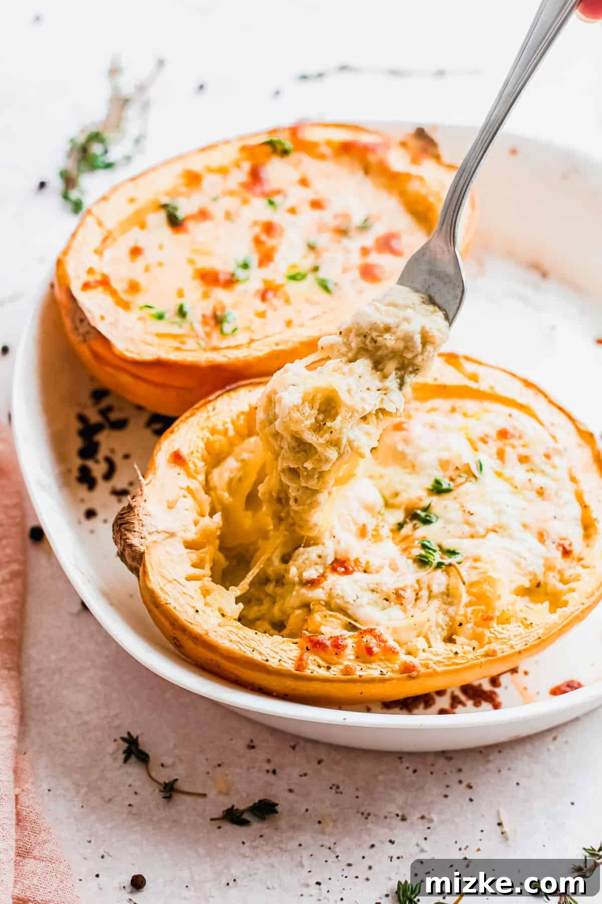 Lifting forkful of spaghetti squash from spaghetti squash boat