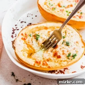 Fork digging into cheesy pesto spaghetti squash boat