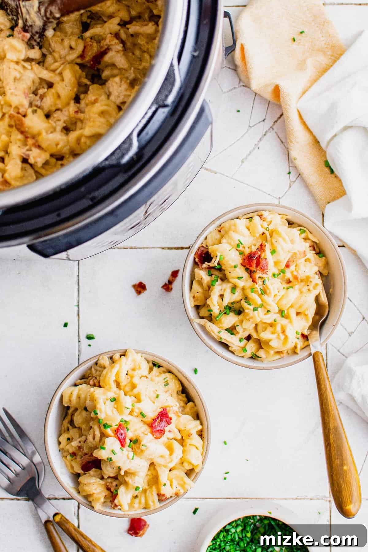 Overhead view of Instant Pot and two bowls filled with chicken pasta