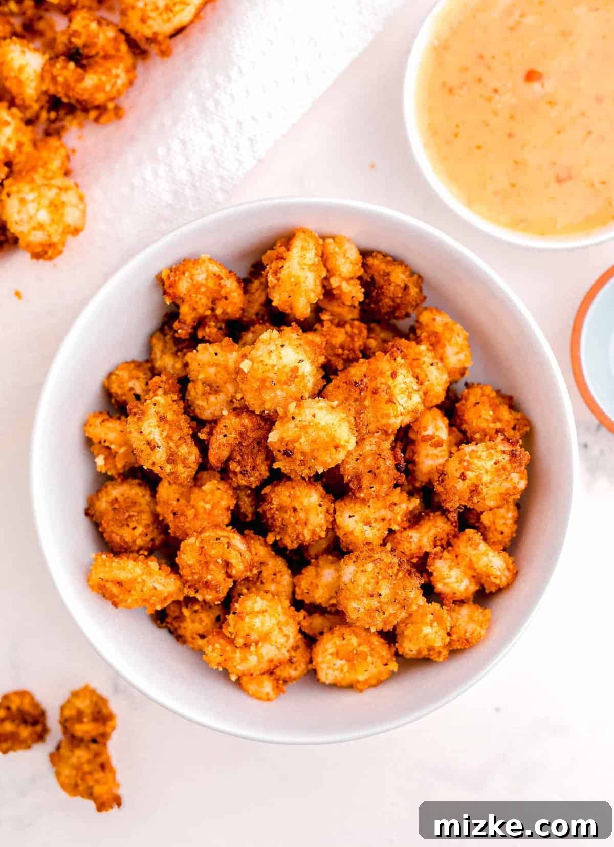 Dynamite Shrimp 11 the fried shrimp in a large white bowl next to the mayo mixture