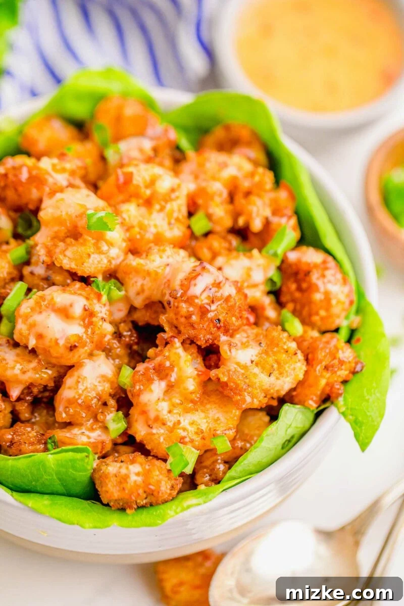Dynamite Shrimp 3 A serving of shrimp is garnished with chopped green onions.