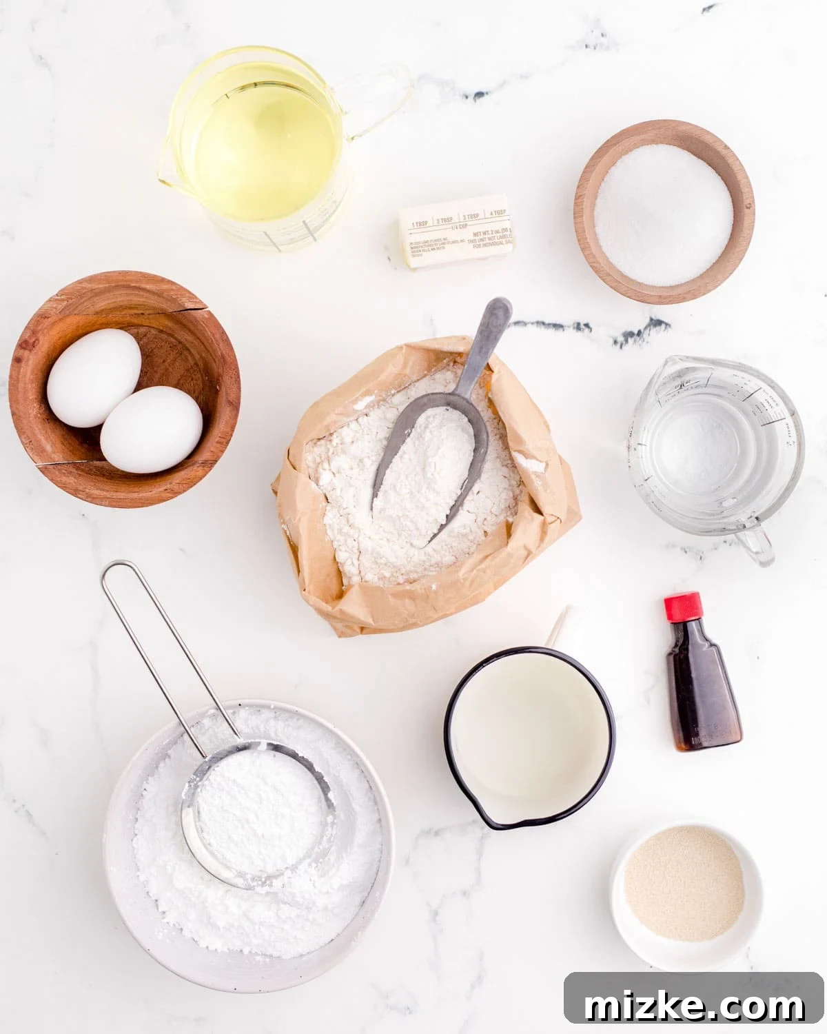 Pillowy Beignet Perfection 3 Ingredients for making homemade beignets laid out on a kitchen counter.