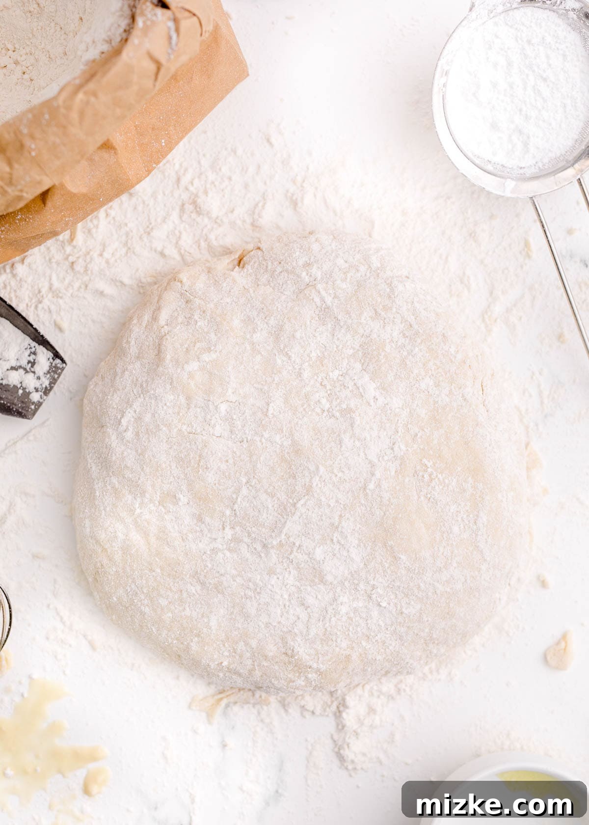 Pillowy Beignet Perfection 6 Dough rolled out into a large circle on a floured work surface, ready for cutting.