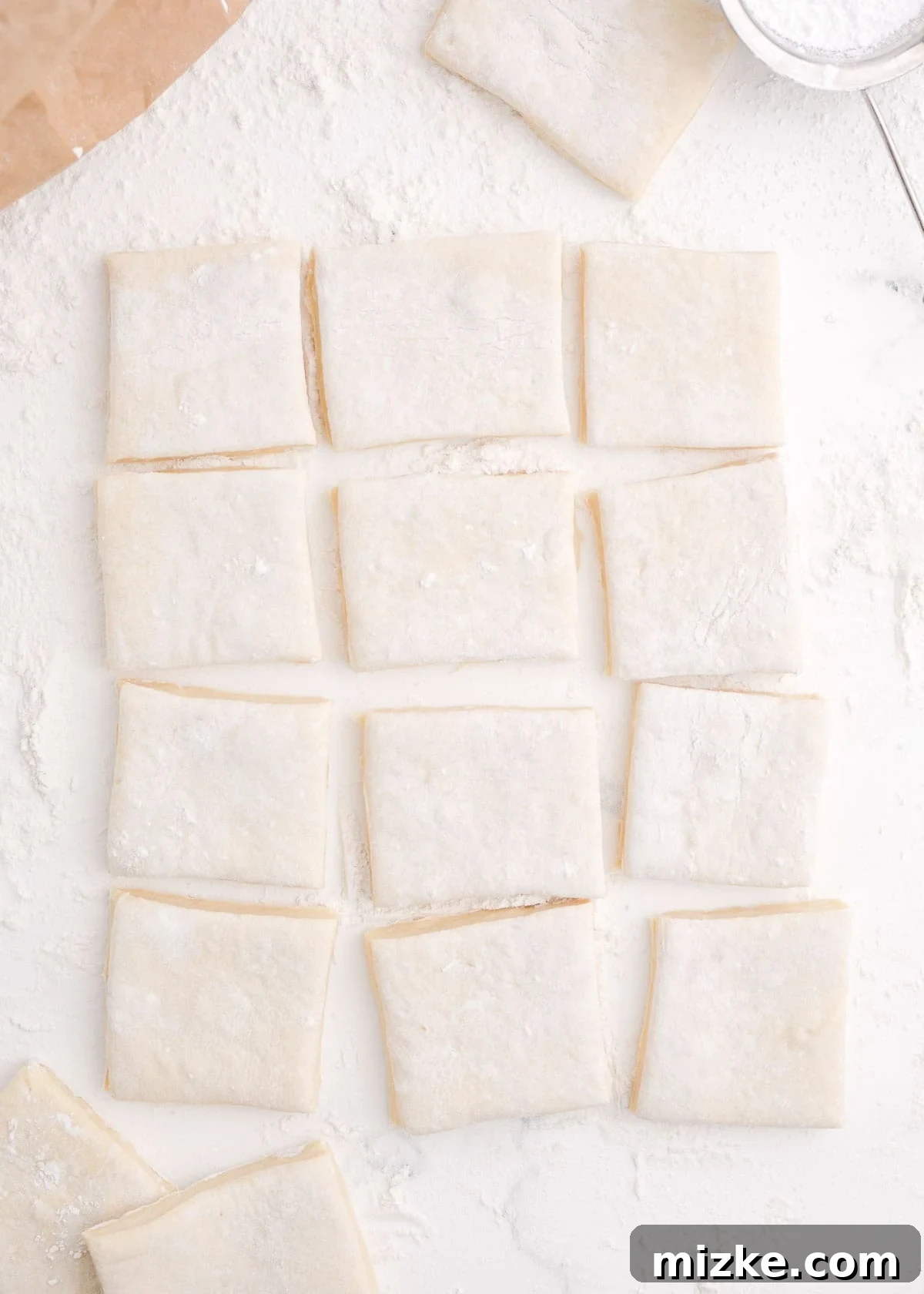 Pillowy Beignet Perfection 7 Dough cut into 12 squares for the classic beignet shape.