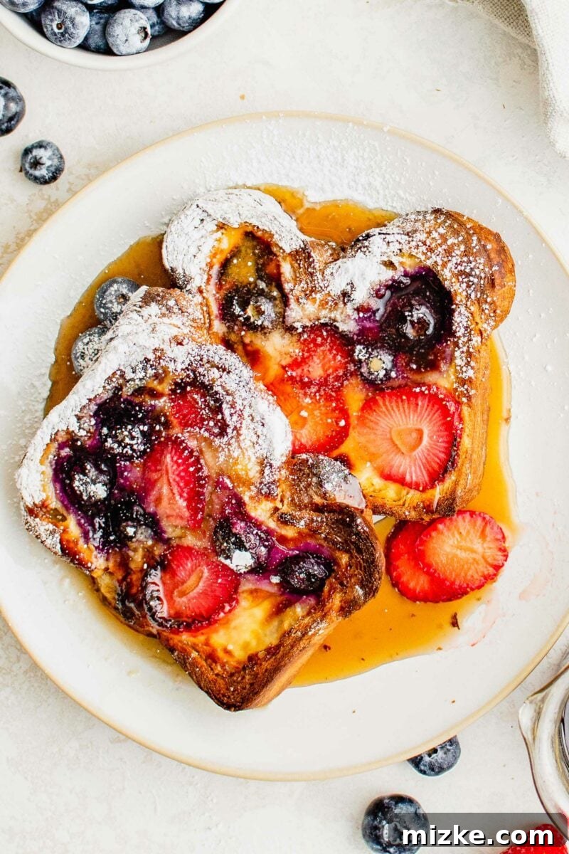 Creamy Yogurt Custard Toast 5 Two perfectly cooked slices of custard yogurt toast, generously drizzled with golden maple syrup, arranged on a clean white plate.