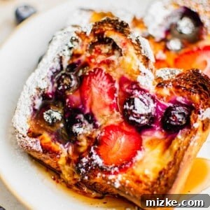 A golden-brown custard yogurt toast garnished with fresh berries.