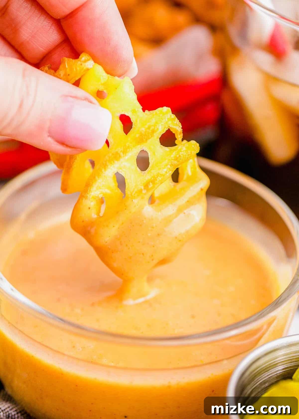 Restaurant Style Chick-Fil-A Sauce 4 Hand dipping waffle fry into Chick-Fil-A sauce