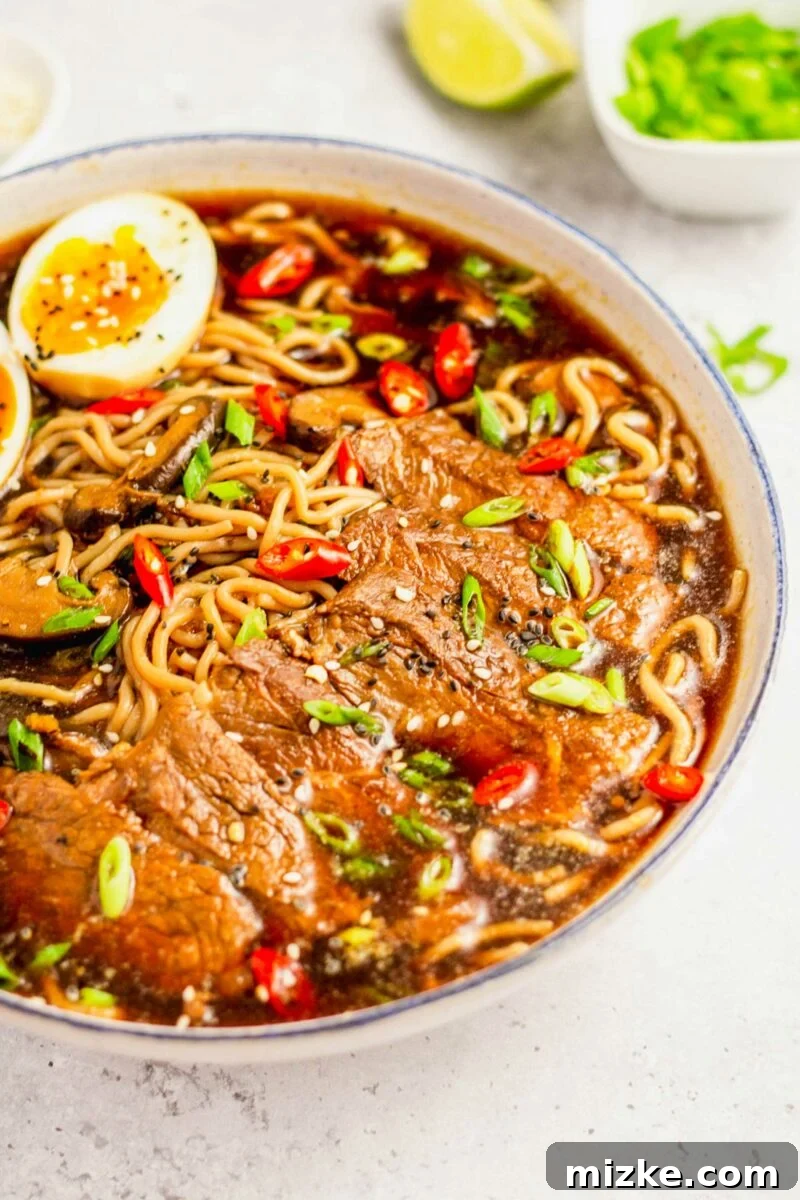 Beef Ramen Bliss 4 A vibrant bowl of beef ramen, beautifully garnished with freshly sliced green onions and a sprinkle of red pepper flakes, ready to be enjoyed.