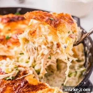 A square image of a baked Chicken Alfredo Pot Pie.
