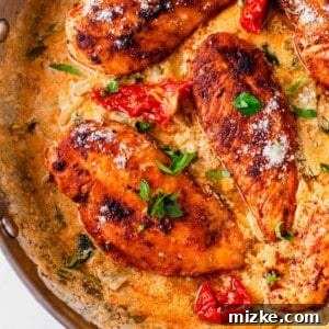 Close-up of a serving of Creamy Tuscan Chicken on a plate, highlighting the rich sauce and tender chicken.