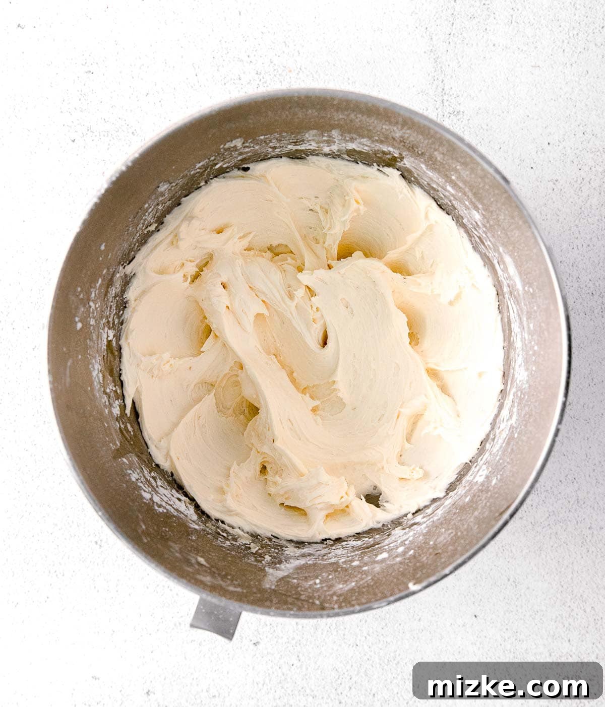 Blossom Honey Lavender Cupcakes 6 Smooth, creamy honey buttercream in a metal stand mixer bowl, perfectly whipped to a light and fluffy consistency, ready for piping.
