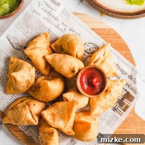 Golden Crispy Vegetable Samosas 7 A close-up of a plate of homemade vegetable samosas, highlighting their crispy texture and golden color.