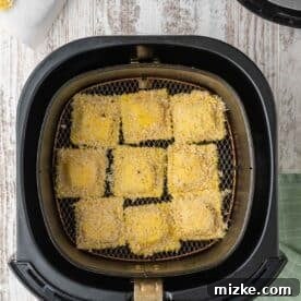 panko-coated ravioli inside an air fryer basket