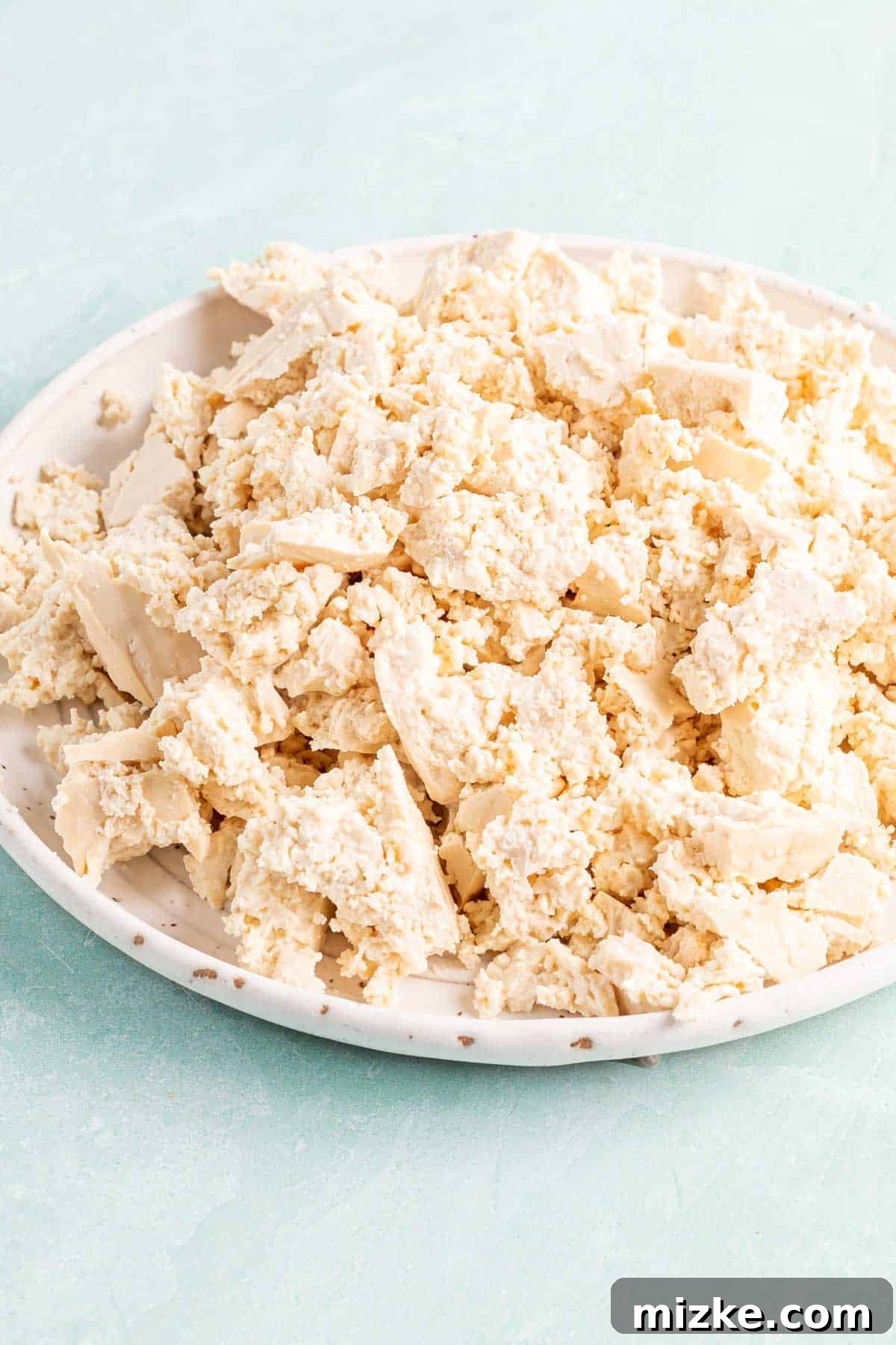 Spicy Tofu Chorizo 3 Crumbled firm tofu on a white plate, ready for cooking.