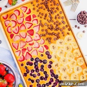 One-Pan Fruity Pancakes 15 Blueberries, strawberries, chocolate chips, and bananas are baked into separate fourths of a sheet pan pancake.