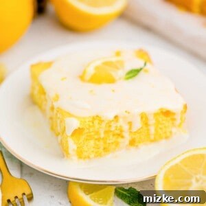 A slice of lemon sheet cake with lemon glaze and fresh lemon garnish.
