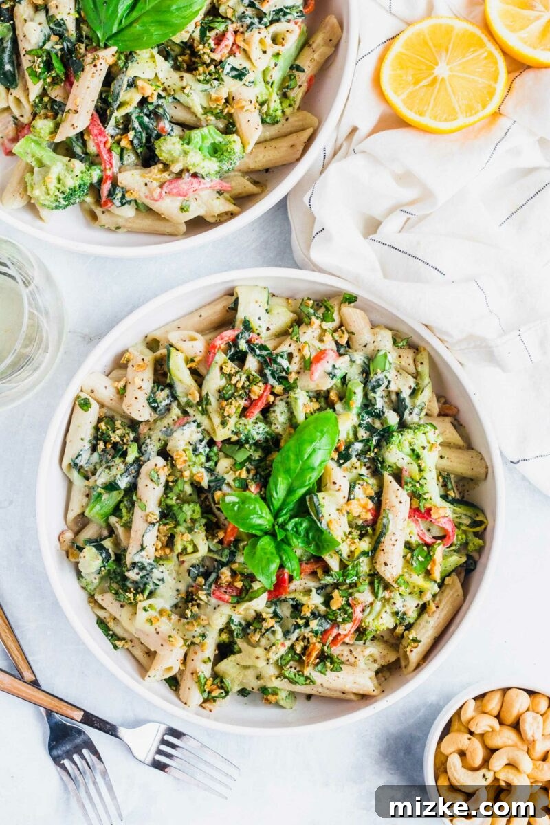 Velvet Cashew Basil Vegan Pasta 6 A few fresh basil leaves serve as a beautiful and aromatic garnish on a perfectly presented bowl of creamy vegan pasta.