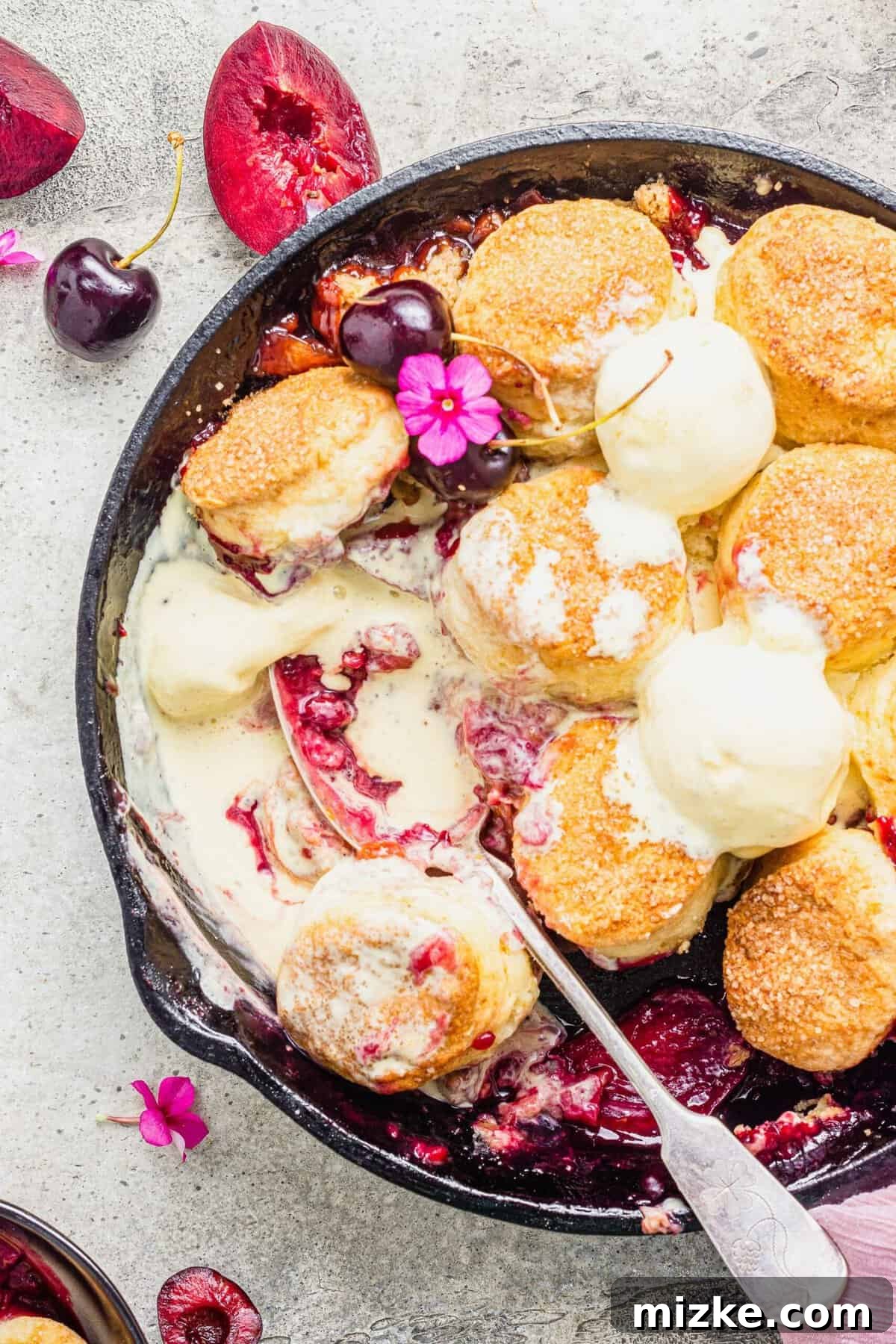 Generously Crusted Stone Fruit Cobbler 5 Overhead view of stone fruit cobbler with biscuits in cast iron skillet