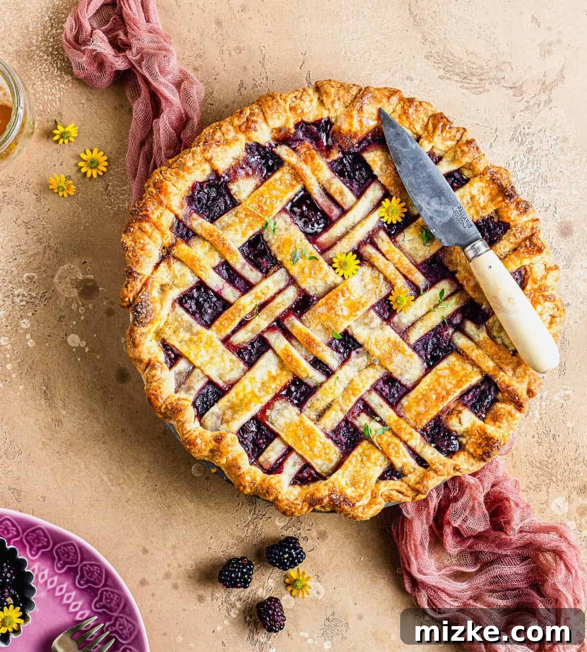 Thyme-Kissed Honey Blackberry Pie 4 Overhead view of a whole honey thyme blackberry pie, freshly baked and golden brown.