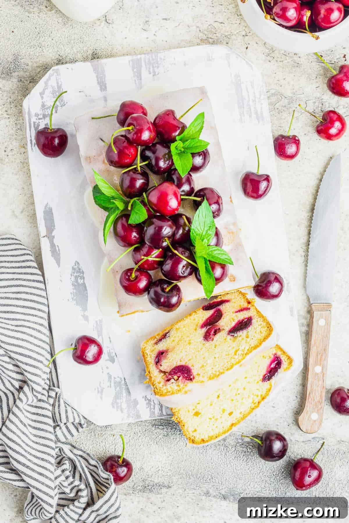 Velvet Cherry Amaretto Loaf 6 Overhead perspective of a cherry amaretto loaf cake, with two generous slices already removed, emphasizing its enticing texture and presentation