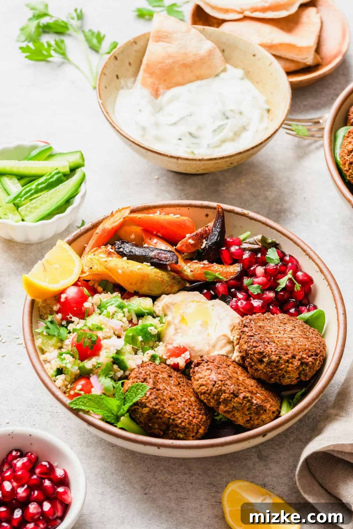 Falafel Harvest Bowl 4 Falafel Buddha bowl served alongside a bowl of refreshing tzatziki dip