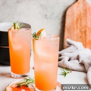 Bitter Sweet Gin and Tonic 6 A close-up shot of a refreshing Grapefruit Gin and Tonic cocktail, garnished with a grapefruit slice, ready to be enjoyed.